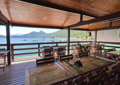 Salão do Restaurante Convés com mesas de madeira abertas para o mar